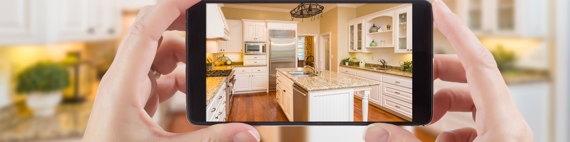 Taking photo of hand painted kitchen on mobile phone in Devon